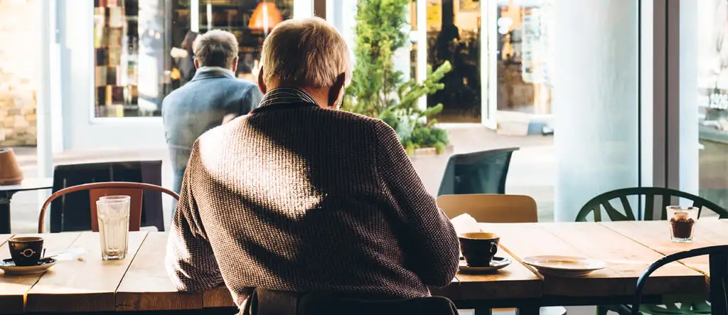 Man enjoying espresso alone in a cafe.