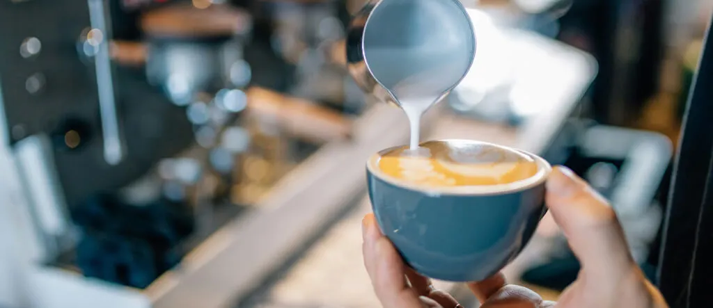 Close-up of a stylish espresso cup filled with a creamy latte.