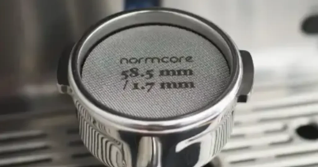 Espresso Shot Screen: What It Is & Why It Matters ☕ 4 Close-up of espresso shot screen on top of tamped coffee grounds to improve water distribution, reduce channeling, and keep the group head clean