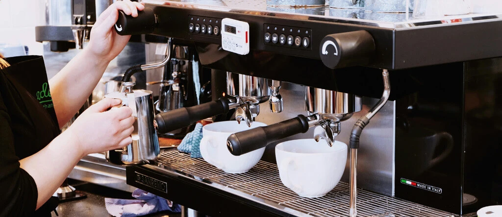 Barista operating an espresso machine