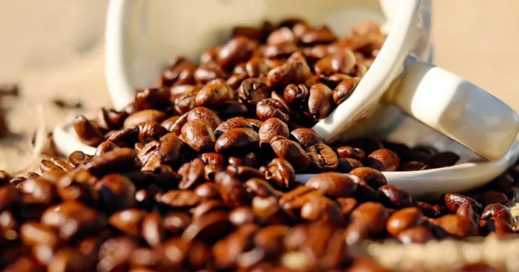 Best Espresso Coffee Beans ☕ for Bold, Balanced Shots 110 Close-up of the best espresso coffee beans spilling out of a white cup