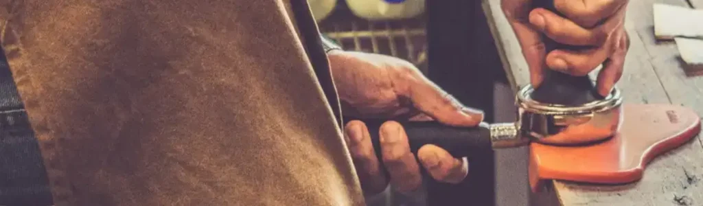 How to Tamp Espresso Like a Barista ☕ 86 Close-up of a barista tamping espresso grounds in a portafilter