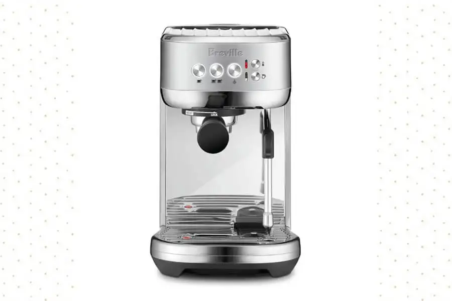 Breville Bambino Plus espresso machine in a modern kitchen setup, showing its compact design and features.