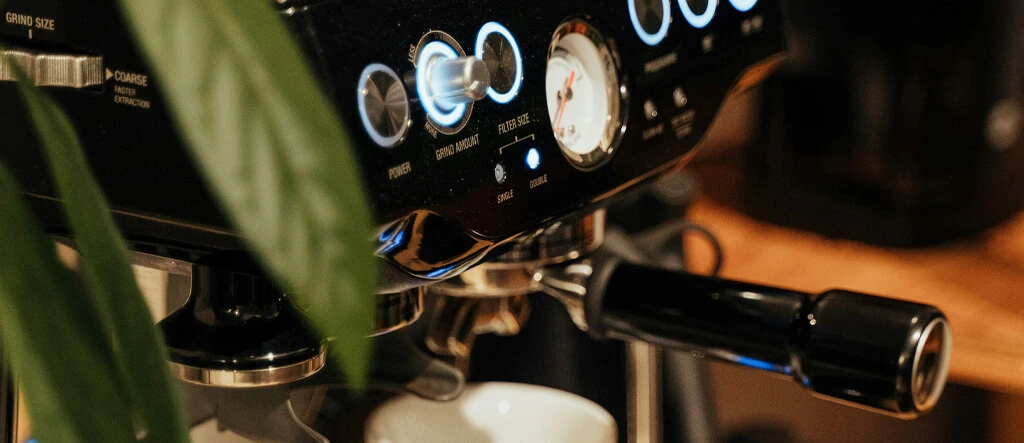 Espresso machine with coffee beans and grinder, illustrating the selection process for choosing the best home espresso grinders.