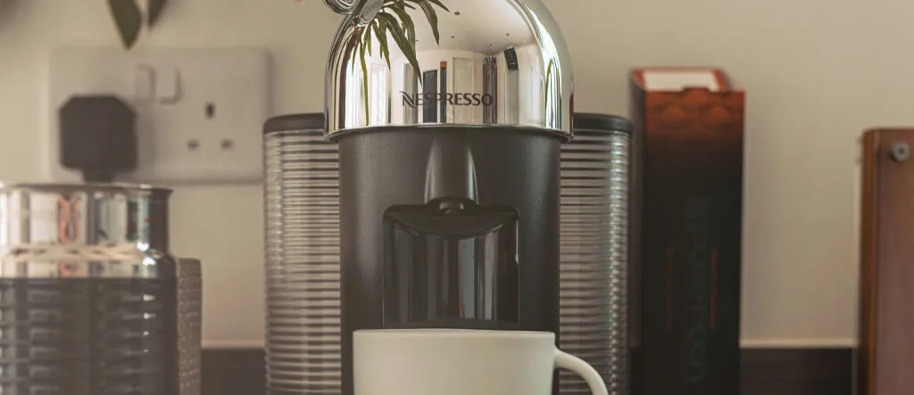 Close-up view of the Nespresso pod espresso machine with a metallic finish.