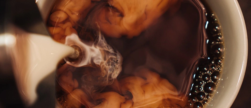 Close-up of golden crema on a cup of freshly brewed espresso