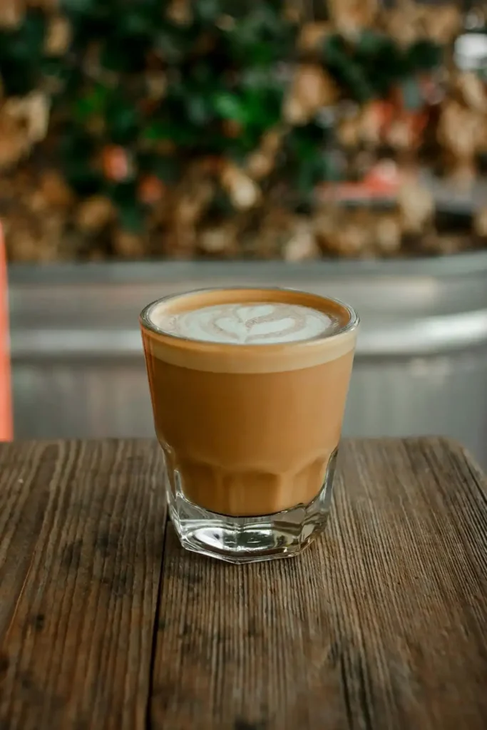 A glass of cortado coffee with equal parts espresso and milk