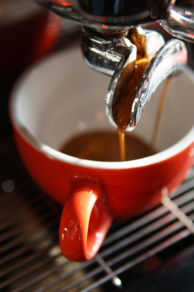 Ristretto espresso being extracted into a small cup from an espresso machine