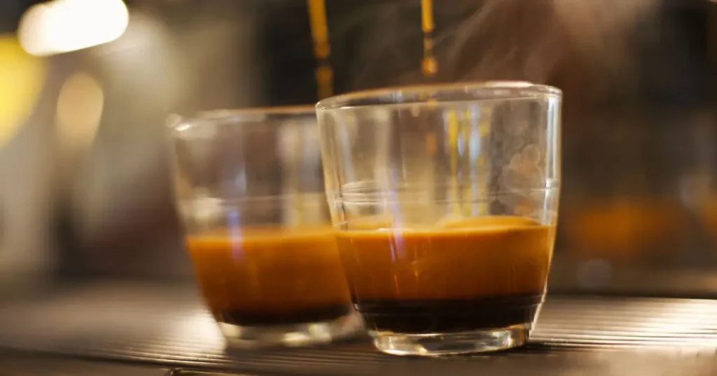 What Is a Ristretto? Taste, Caffeine & How It's Made☕ 4 Two rich ristretto shots topped with velvety golden crema in a small espresso shot glass
