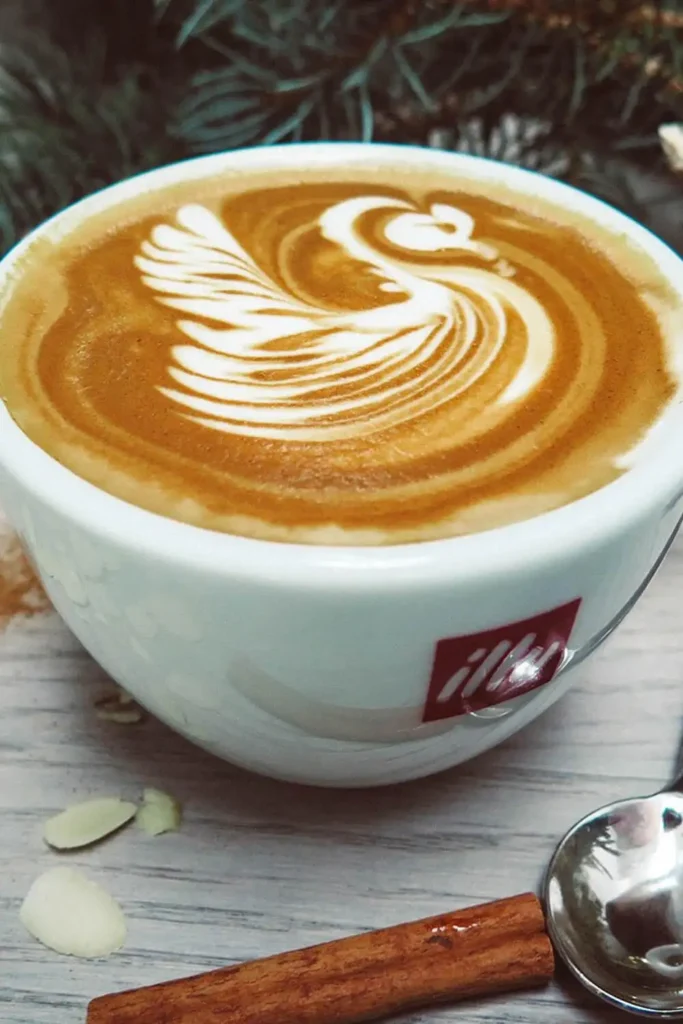 A beautifully crafted swan latte art design, showcasing intricate swirls and elegance in a cup of coffee.