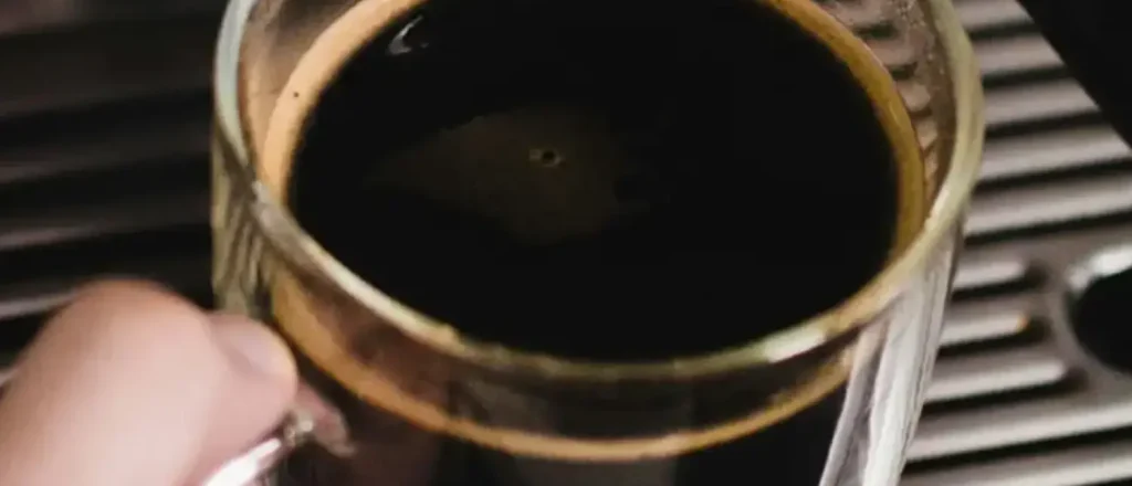 What Is an Americano? Taste, Recipe & Caffeine Guide☕ 35 A steaming cup of Americano coffee on a table, showcasing its rich color and smooth texture.
