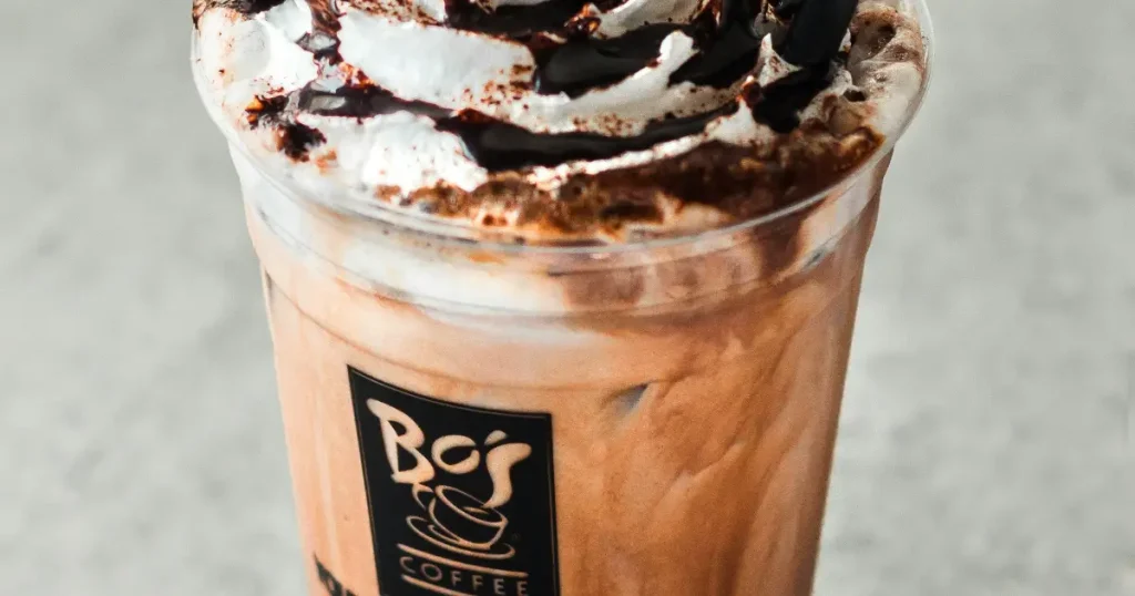 Caffè Mocha: What Is This Chocolate Espresso Drink?☕🍫 4 A caffe mocha coffee drink with chocolate swirls and whipped cream and chocolate syrup topping.
