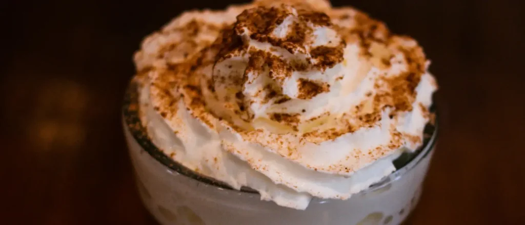 Caffè Mocha: What Is This Chocolate Espresso Drink?☕🍫 36 Top view of a Caffè Mocha with whipped cream and chocolate flakes, showcasing its rich and creamy texture.