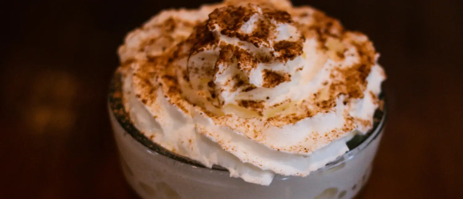 Caffè Mocha: What Is This Chocolate Espresso Drink?☕🍫 2 Top view of a Caffè Mocha with whipped cream and chocolate flakes, showcasing its rich and creamy texture.