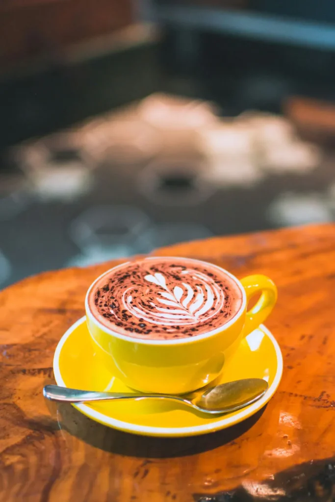 A cup of Caffè Mocha with intricate latte art on top, showcasing the perfect blend of espresso, chocolate, and steamed milk.