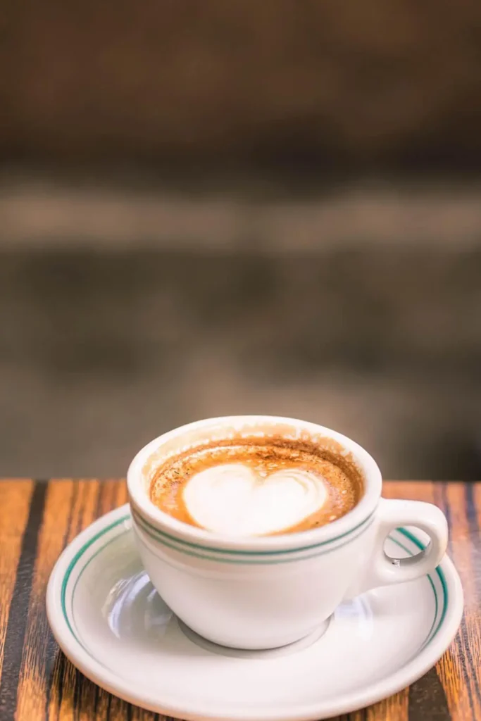 Heart-shaped latte art on a cup of coffee for beginners