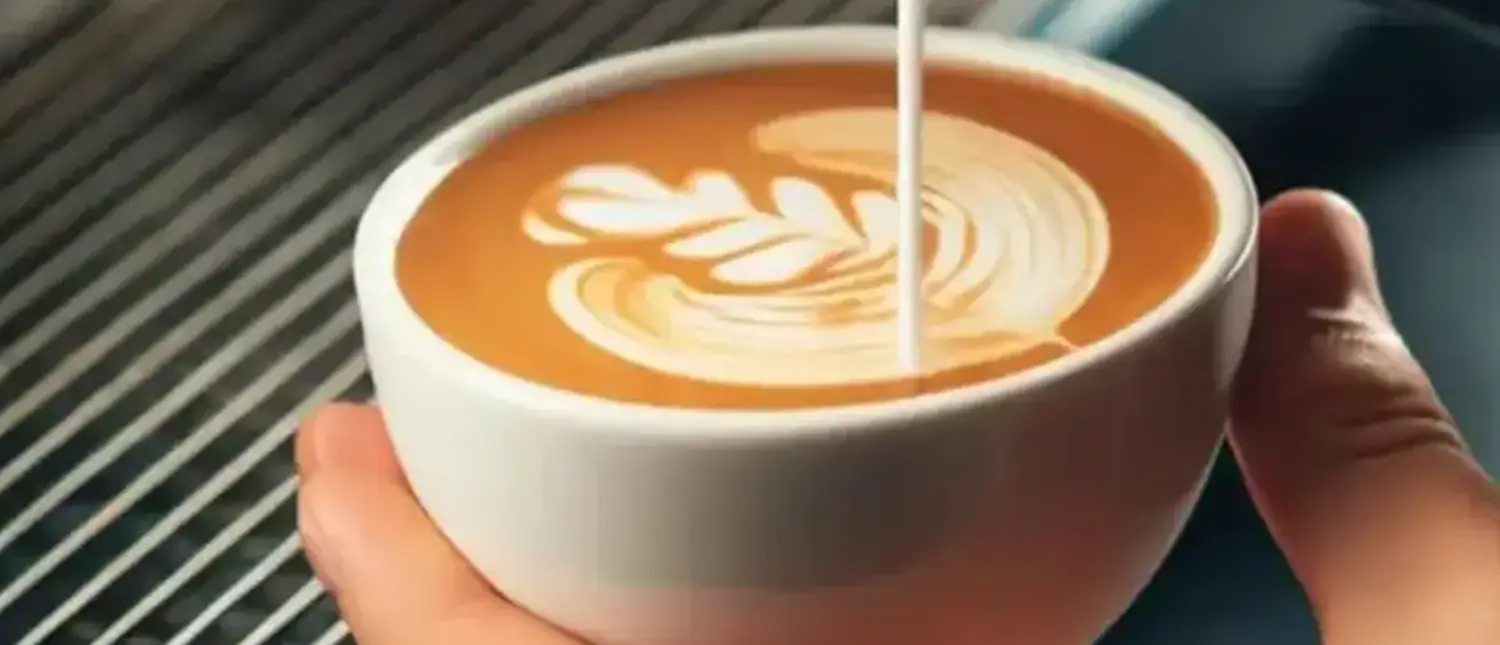 Latte Art for Beginners - Creating Café-Worthy Designs at Home 🎨 2 Barista pouring milk to create heart-shaped latte art to show how latte art for beginners is possible