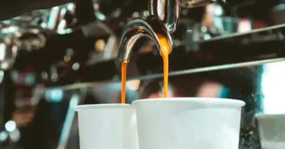 A Beginner's Guide to Making Espresso at Home 2 Espresso machine extracting rich coffee into two cups, highlighting brew consistency.