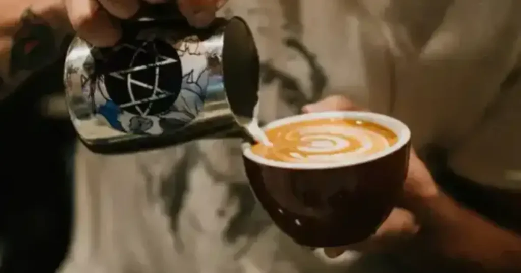 Best Cappuccino Cups - Elevate Your Coffee Experience☕ 33 Barista pouring steamed milk into the best cappuccino cups, creating latte art