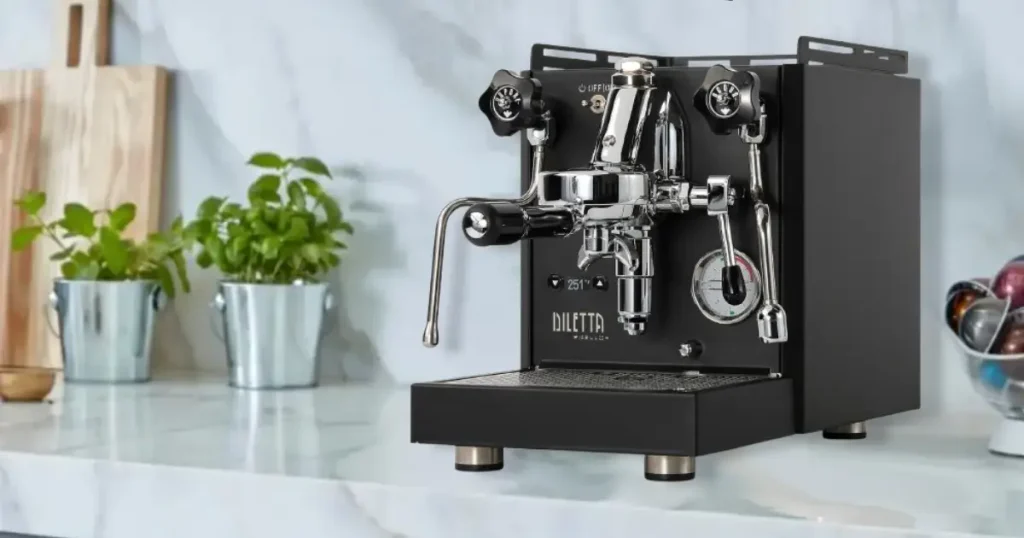 Diletta Bello+ Espresso Machine Review 36 Diletta Bello+ Espresso Machine with polished stainless-steel body and E61 group head on a kitchen counter