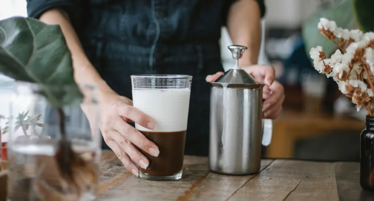 Elevate Your Coffee Game - Best Milk Frothers of 2026 ☕ 2 Barista showing milk froth on coffee using one of the best milk frothers