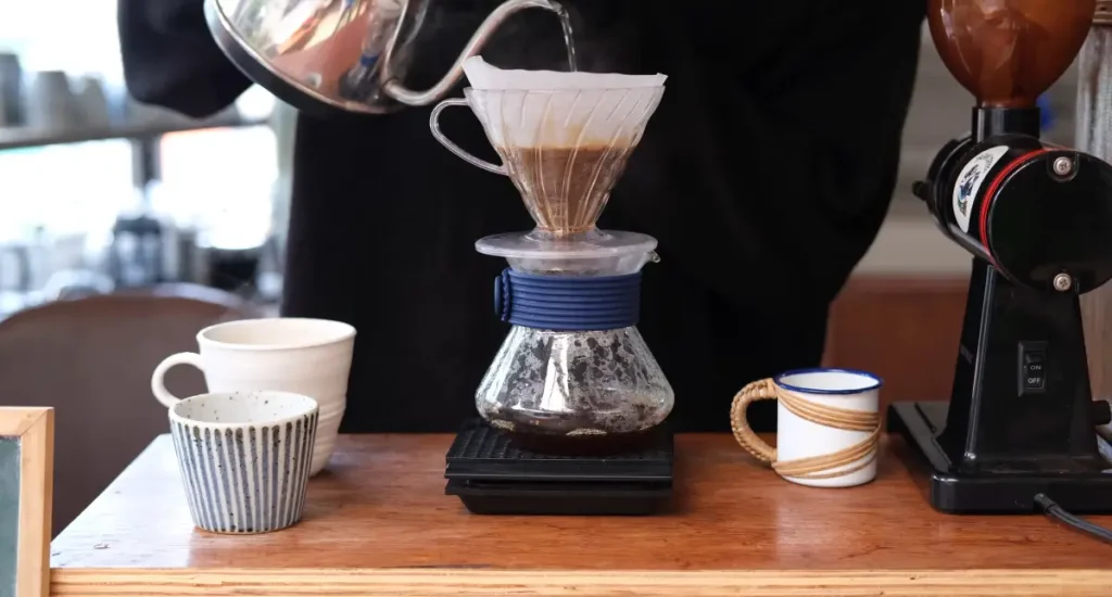 Espresso vs Turkish vs Drip Coffee: Which Is Best? 6 Freshly brewed drip coffee in a carafe with coffee beans and a filter in the background