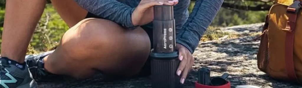 🧳 AeroPress Go Review: The Compact Brewer Made for Travel 74 Woman brewing coffee outdoors using the AeroPress Go