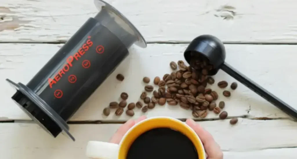 AeroPress Review: The Portable Brewer That Packs a Punch ☕ 91 AeroPress coffee makers on a wooden table – the Original model shown