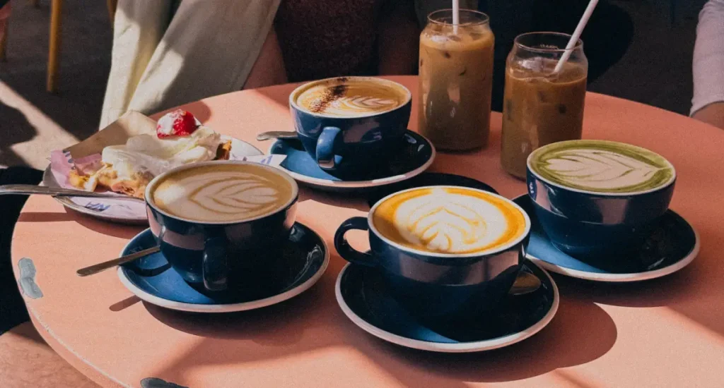 Espresso Drink Recipes to Try at Home ☕ 82 Assorted espresso drinks including lattes, mochas, and iced coffee served on a wooden table