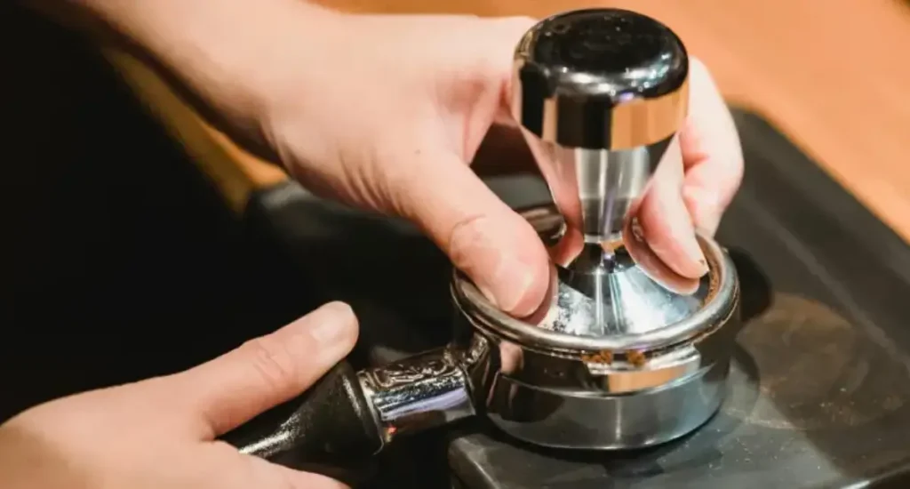 5 Tamping Mistakes And How to Fix Them 80 Barista tamping ground espresso on a tamping mat
