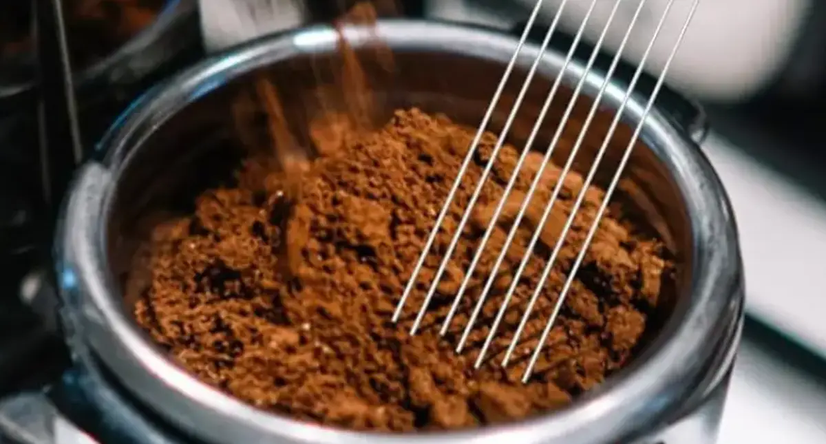 What is a WDT Tool? Your Beginner’s Guide to Better Espresso Shots 2 Person using a WDT tool to distribute espresso grounds evenly in a portafilter