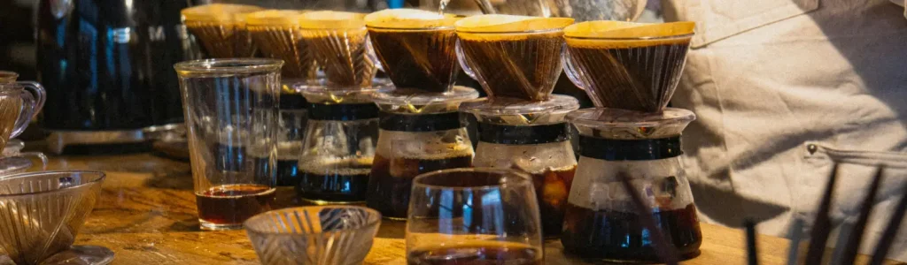 How to Brew Pour Over Coffee (Step-by-Step) 70 Barista brewing six pour over coffees simultaneously using a multi-station pour over setup.