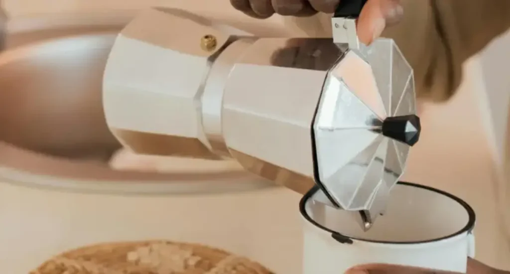 Best Moka Pots for Strong, Stovetop Coffee ☕ 147 Person making coffee with one of the best Moka pots on the stovetop