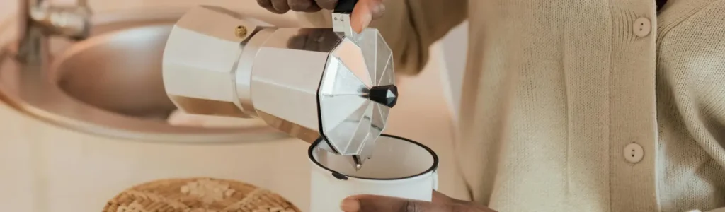 How to Make a Perfect Moka Pot Coffee at Home 25 Person making coffee with a Moka pot on the stovetop