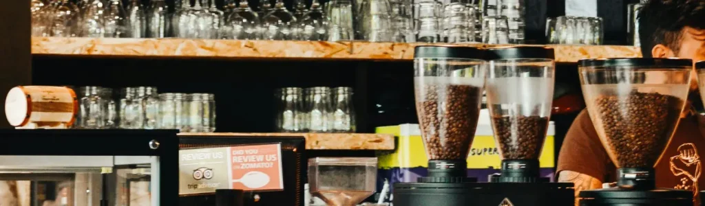 Coffee Gift Ideas for Espresso Lovers (Perfect for Every Occasion)🎁 110 Coffee glasses, espresso gear, and accessories displayed on shelves in a cozy home coffee bar