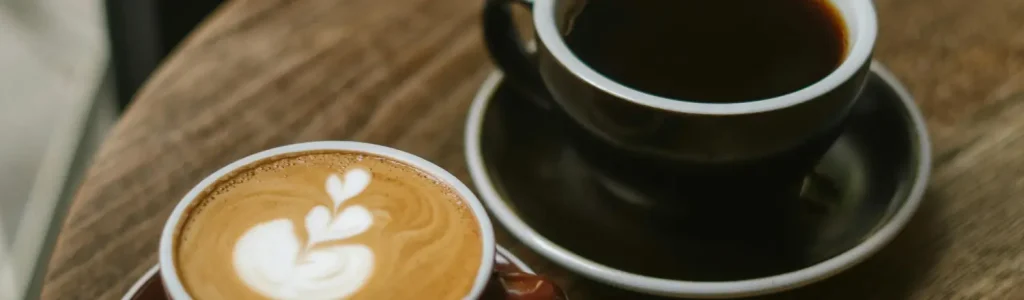 ☕ Espresso vs Coffee – What’s the Difference? 29 A cup of espresso and a mug of coffee side by side on a café table
