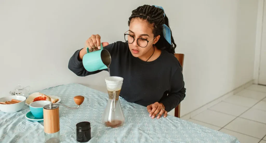 How to Brew Pour Over Coffee (Step-by-Step) 3 Person demonstrating how to brew pour over coffee in an everyday setting