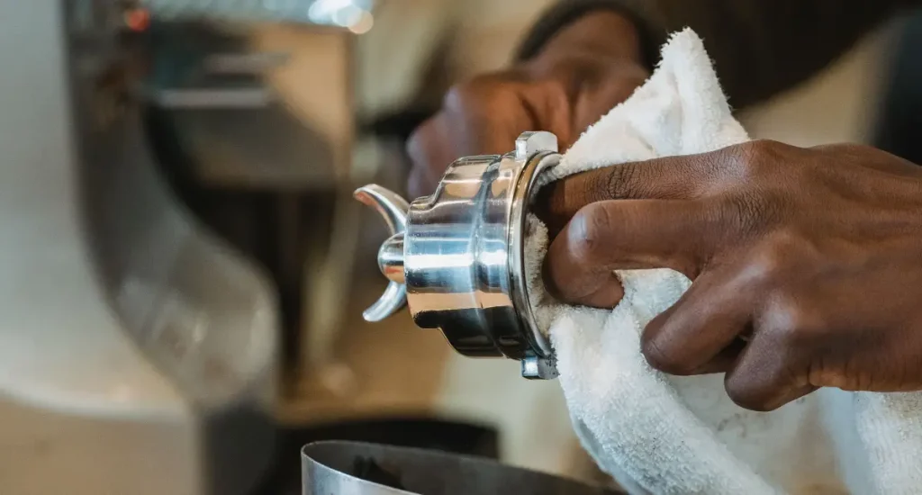 How to Easily Clean an Espresso Machine Like a Real Pro 🧼 4 Barista showing how to clean an espresso machine portafilter with a cloth