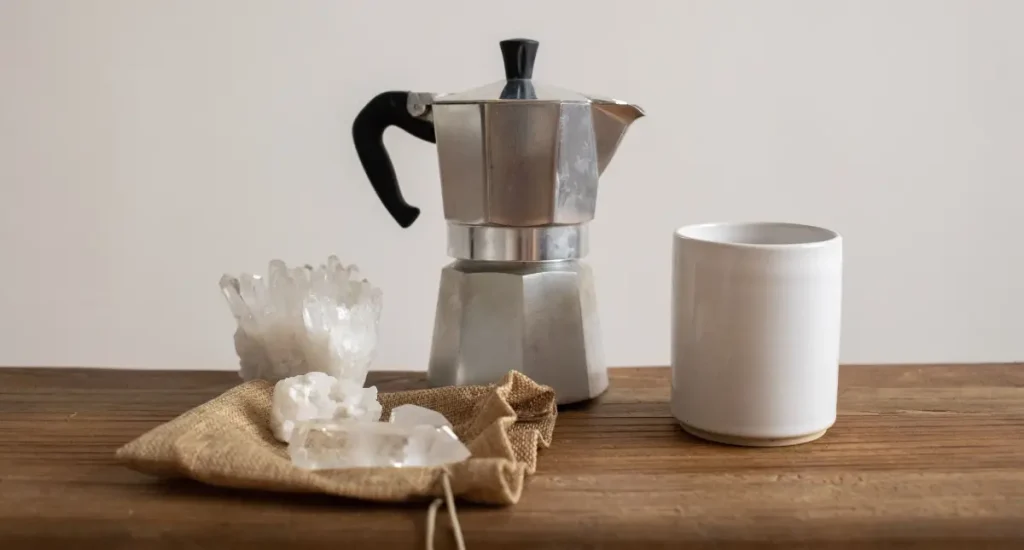 How to Use a Moka Pot (Beginner-Friendly Guide)☕ 61 How to use a moka pot - Moka pot and fresh coffee served in a cup on a wooden table
