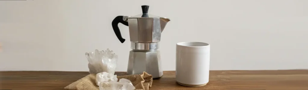 ☕ How to Use a Moka Pot (Beginner-Friendly Guide) 63 Moka pot and fresh coffee served in a cup on a wooden table