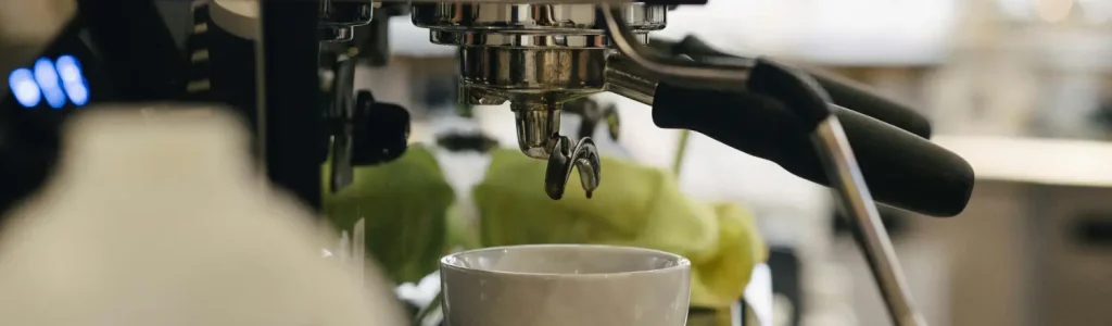 ☕ Best Espresso Machines with Built-In Grinders (2026 Picks for Home Baristas) 132 Close-up of an espresso machine with built-in grinder, showing group head and steam wand.