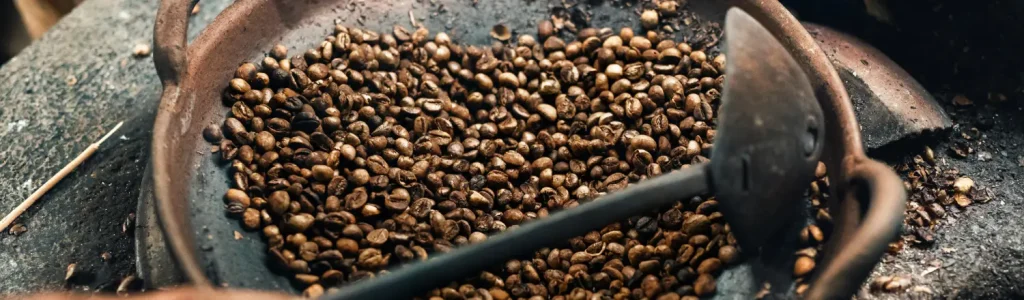 Best Coffee Beans for Cold Brew ☕❄️ Smooth & Bold Picks 108 Old hand coffee roaster filled with roasted beans, perfect for cold brew.
