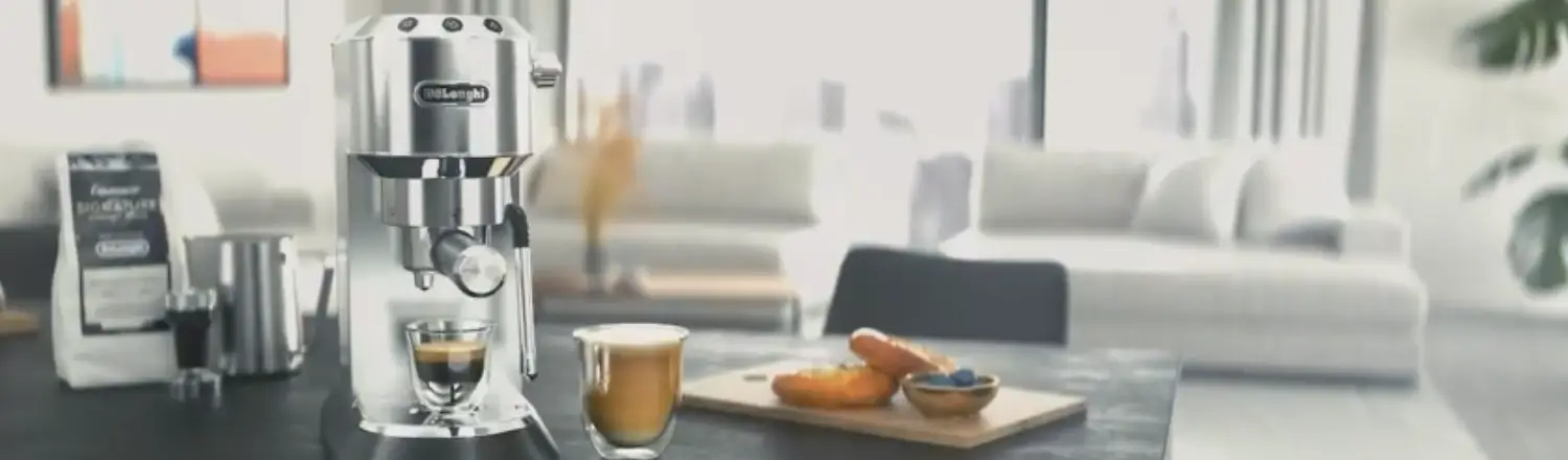 De’Longhi Dedica Review – Slim, Stylish, & Espresso-Ready! ☕ 2 De’Longhi Dedica espresso machine on a kitchen bench with a fresh espresso shot beside it.