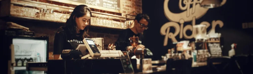 ☕ 10 Pro Home Barista Tips to Brew Café-Quality Coffee (Without Fancy Equipment!) 45 Barista using an espresso machine to brew coffee at home, showcasing café-quality brewing tips.
