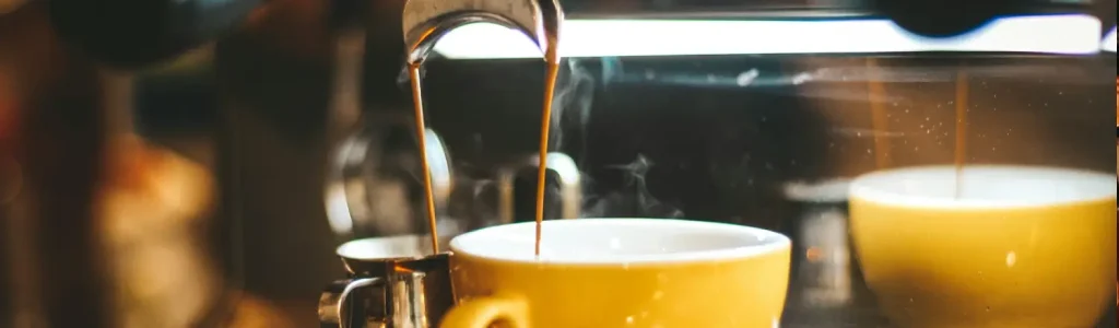 ☕Top 5 Single-Serve Coffee Machines for Home Use 102 Freshly brewed coffee extracting into a yellow coffee cup from a home espresso machine