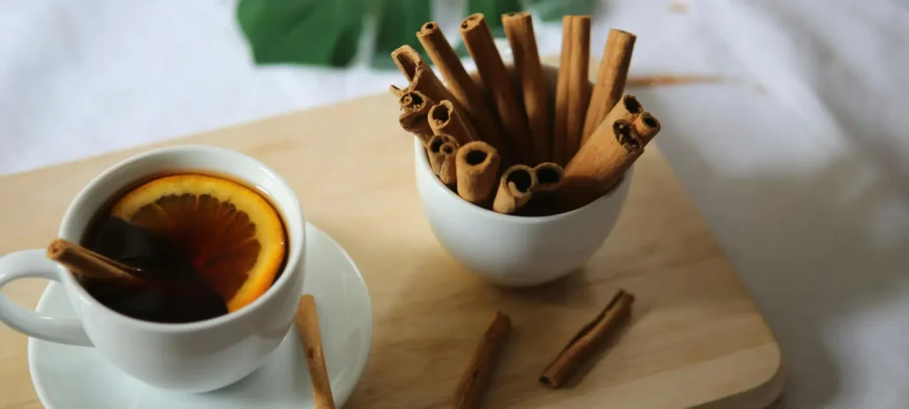 Cinnamon Coffee: Benefits & Recipes to Boost Your Morning ☕✨ 69 Cup of coffee beside cinnamon sticks highlighting the benefits of adding cinnamon to coffee