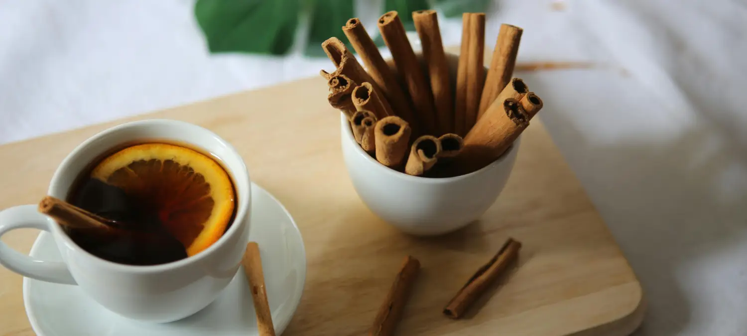 Cinnamon Coffee: Benefits & Recipes to Boost Your Morning ☕✨ 2 Cup of coffee beside cinnamon sticks highlighting the benefits of adding cinnamon to coffee