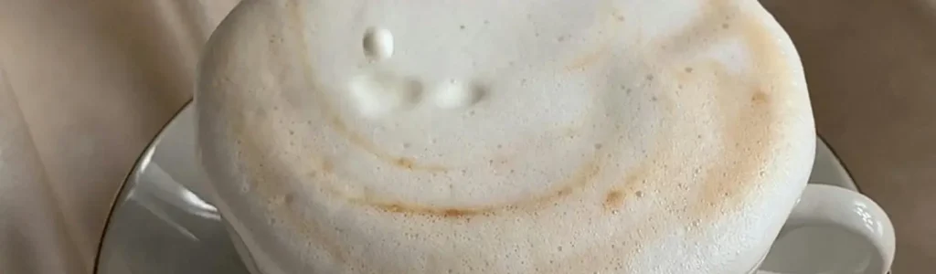How to Froth Milk Without a Steam Wand 🥛✨ 39 Close-up of creamy sweet cream cold foam on top of iced coffee, Starbucks-style.