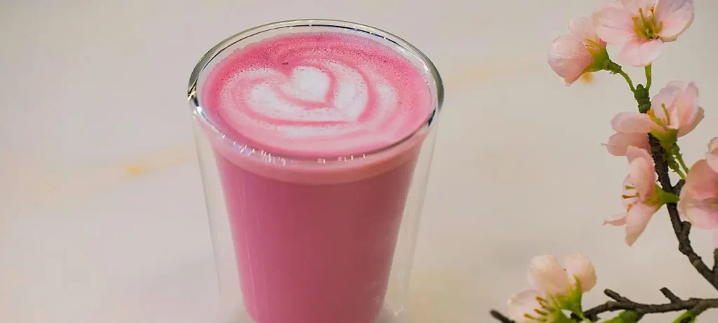🌺 Pink Velvet Latte Recipe (Pretty & Sweet!) 64 Pink velvet latte in a glass topped with creamy milk foam