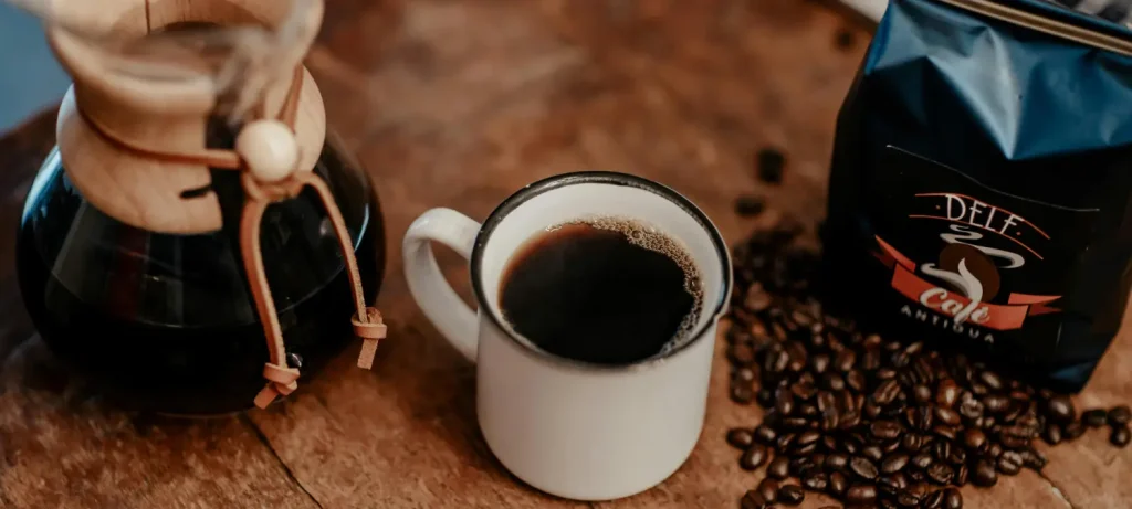 Low Acid Coffee: Better for Sensitive Stomachs? ☕ 43 carafe of brewed coffee cup coffee beans and coffee bag representing low acid coffee options for sensitive stomachs